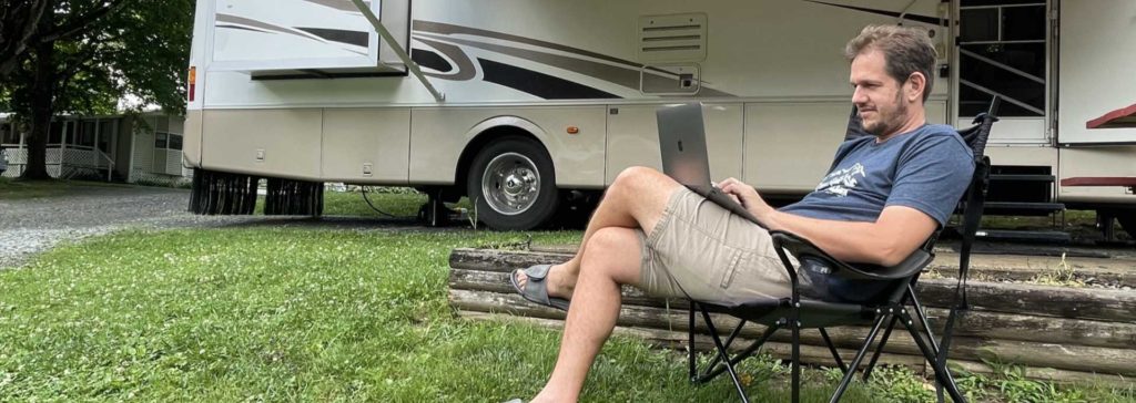 Working on the laptop next to the RV.